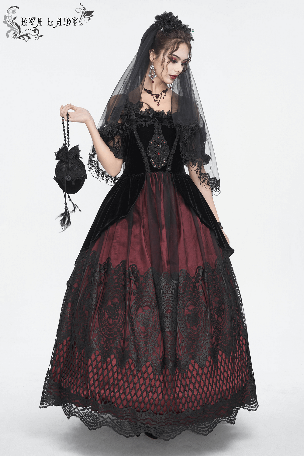 Gothic bridal black dress with elegant lace and tulle veil, perfect for a dramatic wedding look.