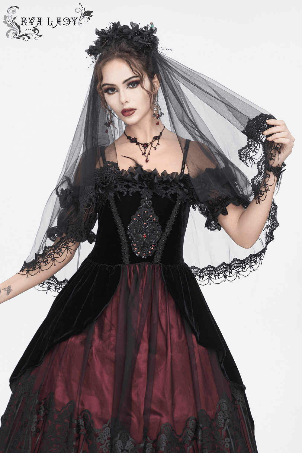 Gothic bridal black veil with flower hair clip, worn by a model in a dark elegant gown, perfect for a unique wedding.