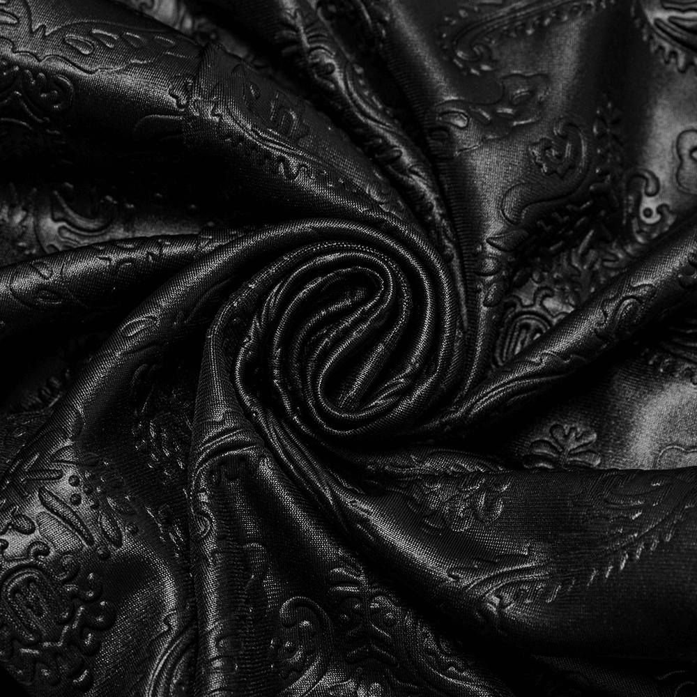Close-up of black embossed fabric with intricate patterns, ideal for gothic style leggings.
