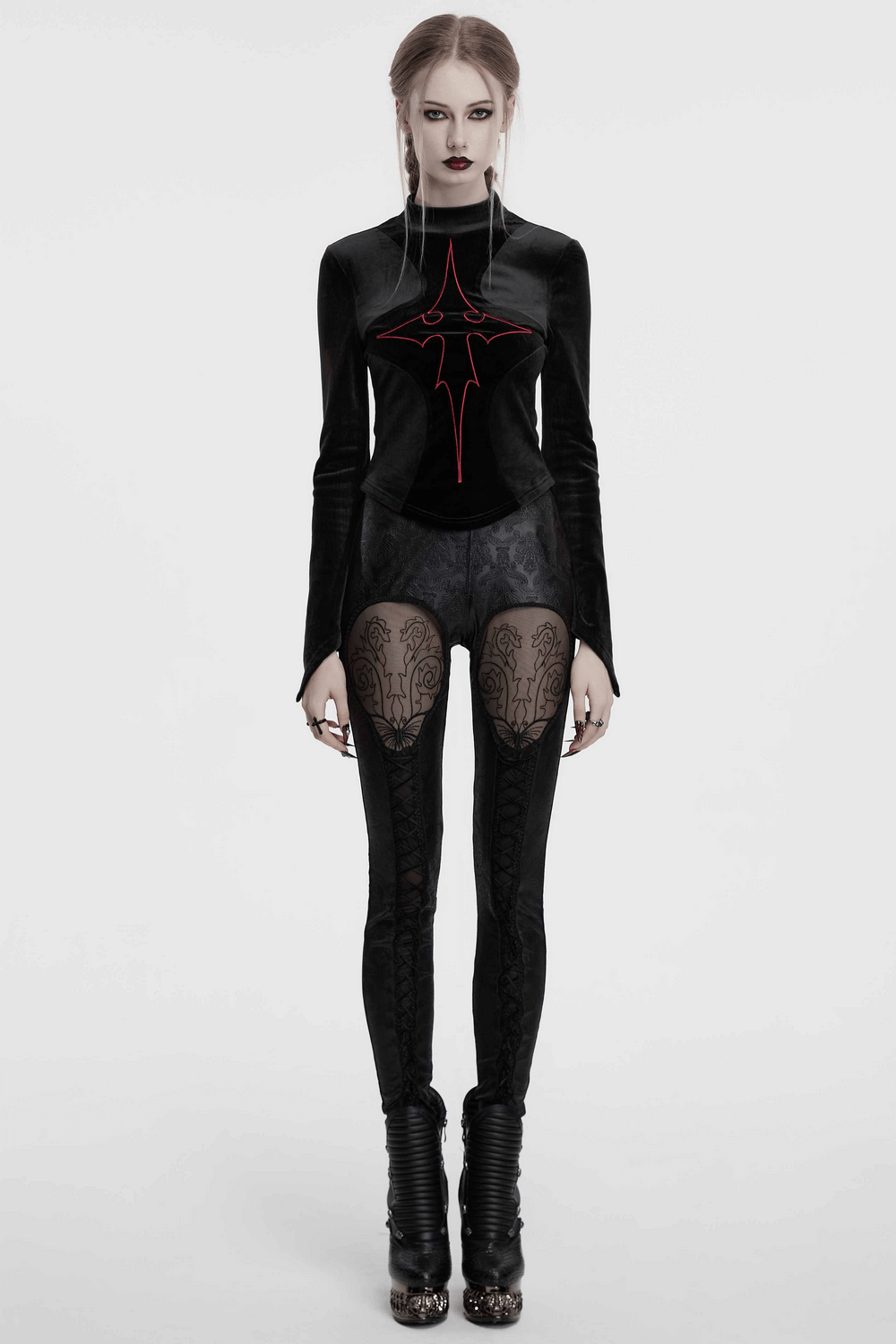 Gothic embossed hollow out leggings with butterfly pattern and drawstrings, styled with black top and edgy boots.