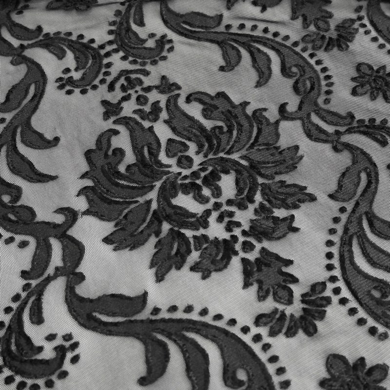 Intricate gothic embroidery design featuring floral patterns on sheer black fabric.