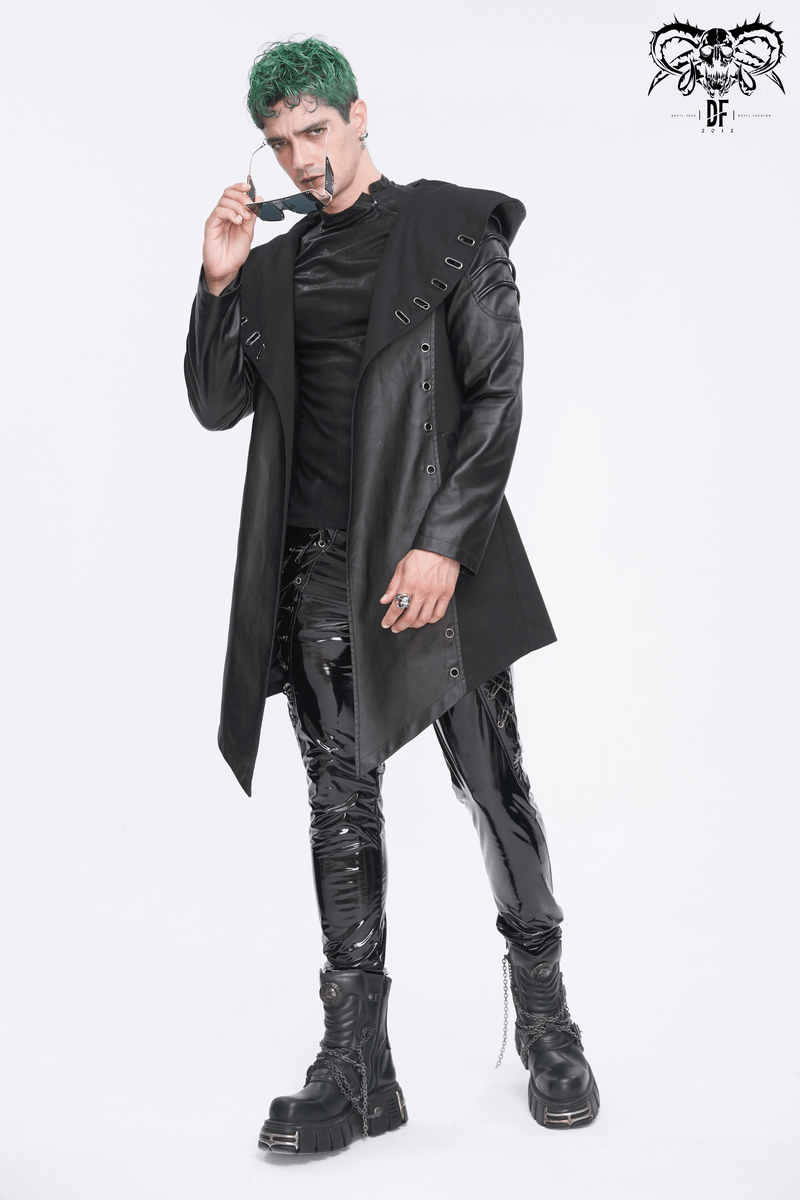 Men's gothic black irregular hooded coat with eyelets, styled with shiny pants and bold accessories.