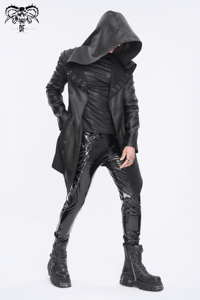 Men's gothic black irregular hooded coat with eyelets, worn with sleek black pants and edgy boots.