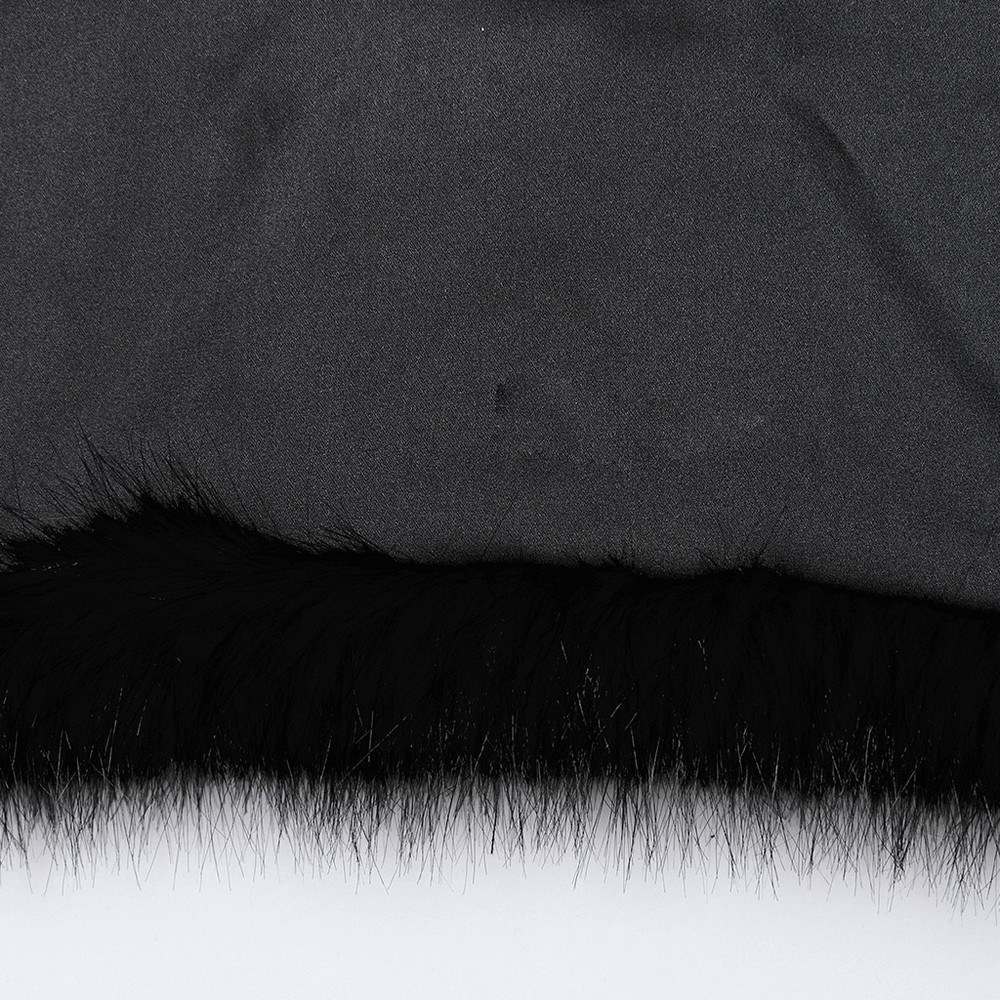 Close-up of the black faux fur hem of a gothic cropped jacket, showcasing a blend of sleek and fluffy fibers.