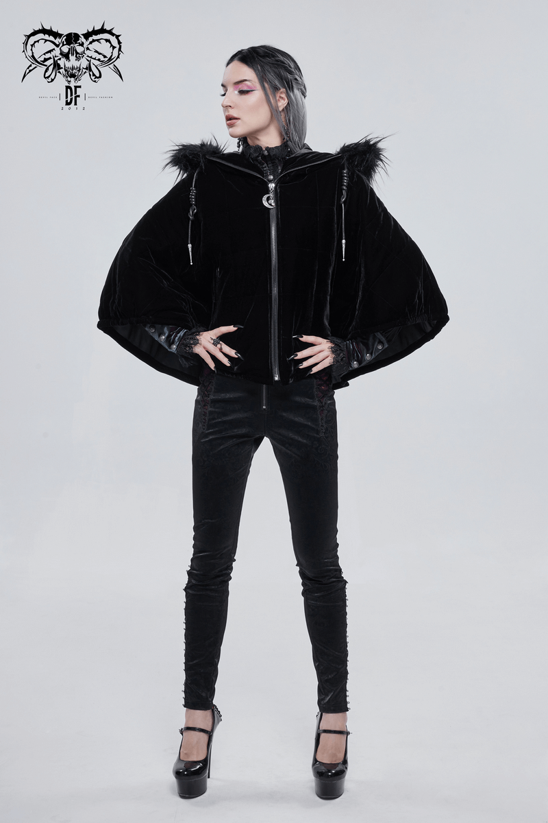 Gothic women in stylish black faux fur hooded cape and skinny pants, showcasing alternative fashion.