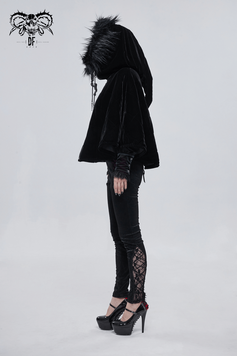 Side view of a woman in a gothic black faux fur hooded cape, paired with stylish black pants and high heels.