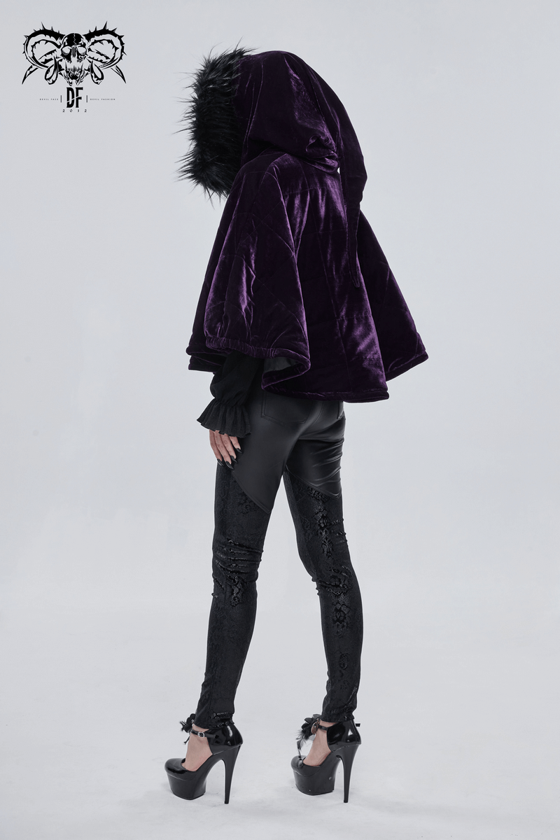 Stylish woman in a purple velvet hooded cape with fur, showcasing gothic fashion paired with sleek black leggings.