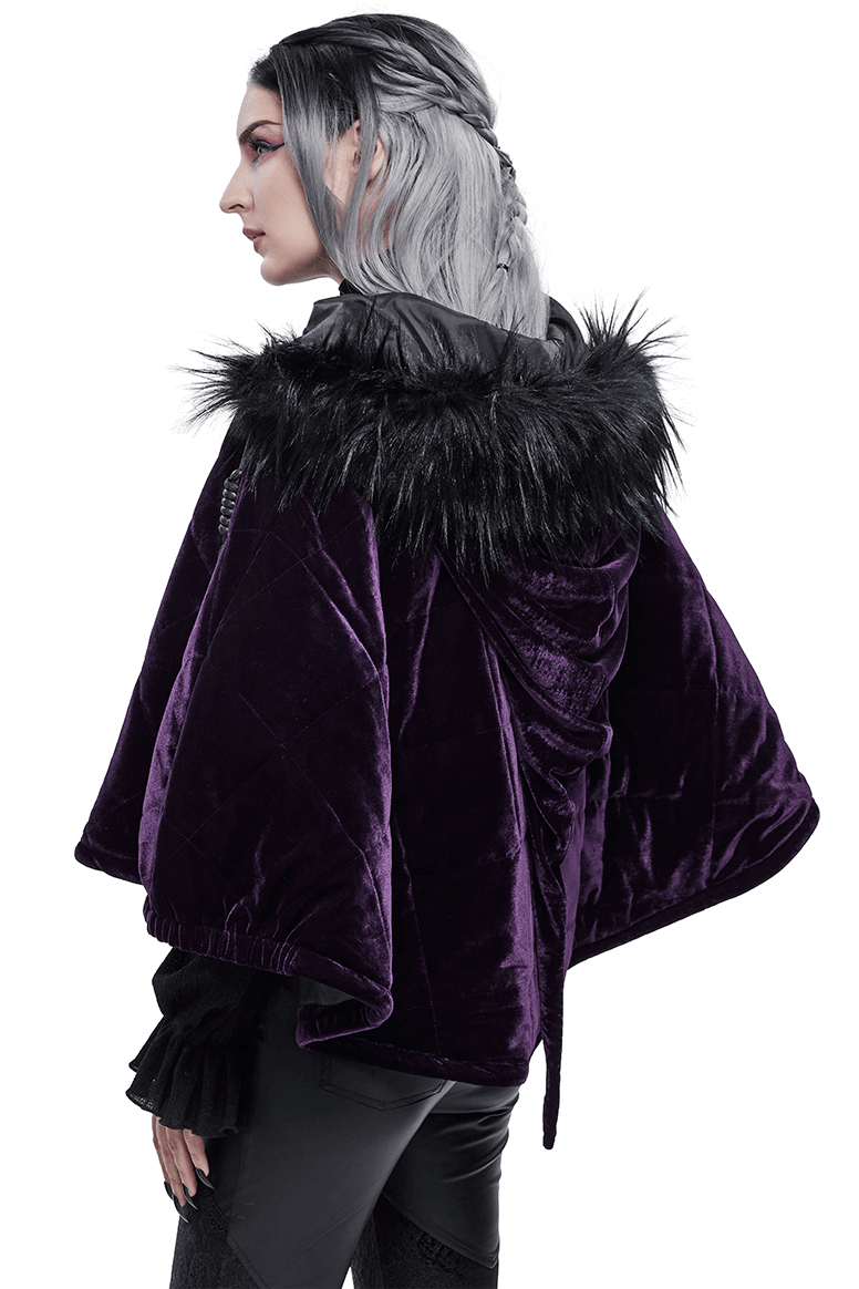 Stylish woman in a purple velvet gothic cape with a fur hood, showcasing elegance and warmth.