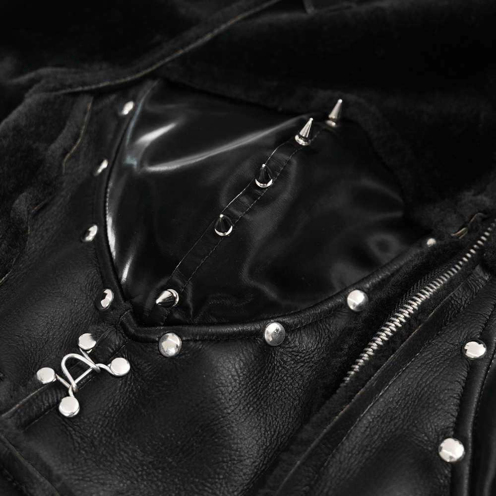 Close-up of gothic faux leather coat with studded accents and lace-up detail, showcasing edgy design.