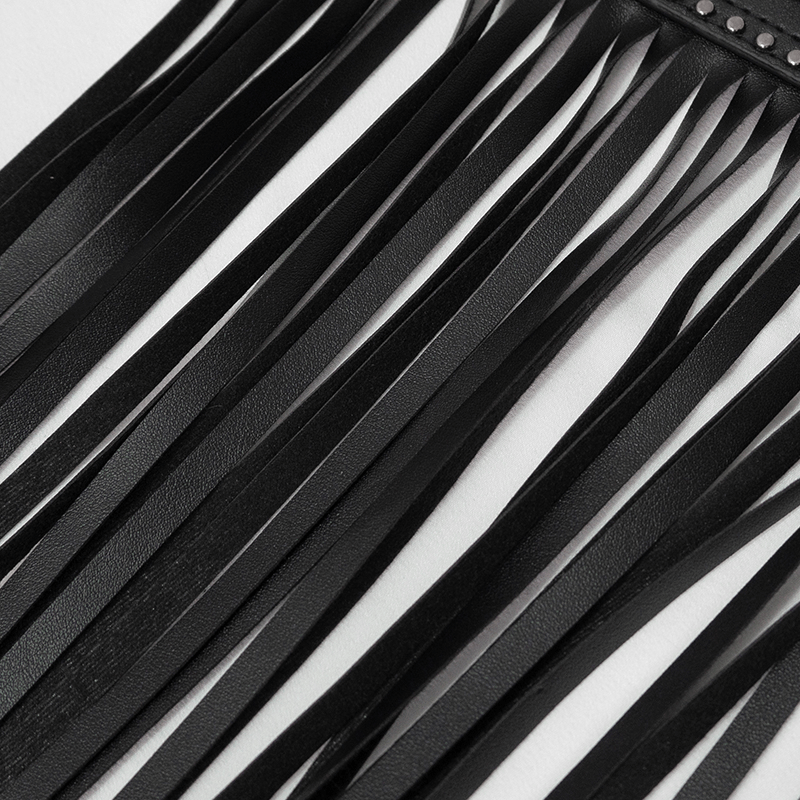 Close-up of black faux leather belt with long tassels and studded detailing, perfect for vintage outfits.