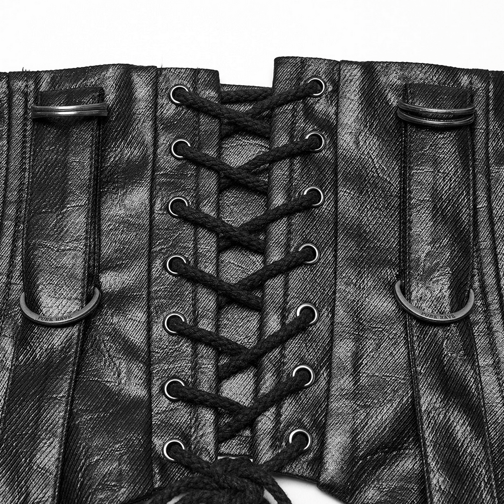 Close-up of gothic faux leather corset showing adjustable laces and bold metal rings for customizable fit.