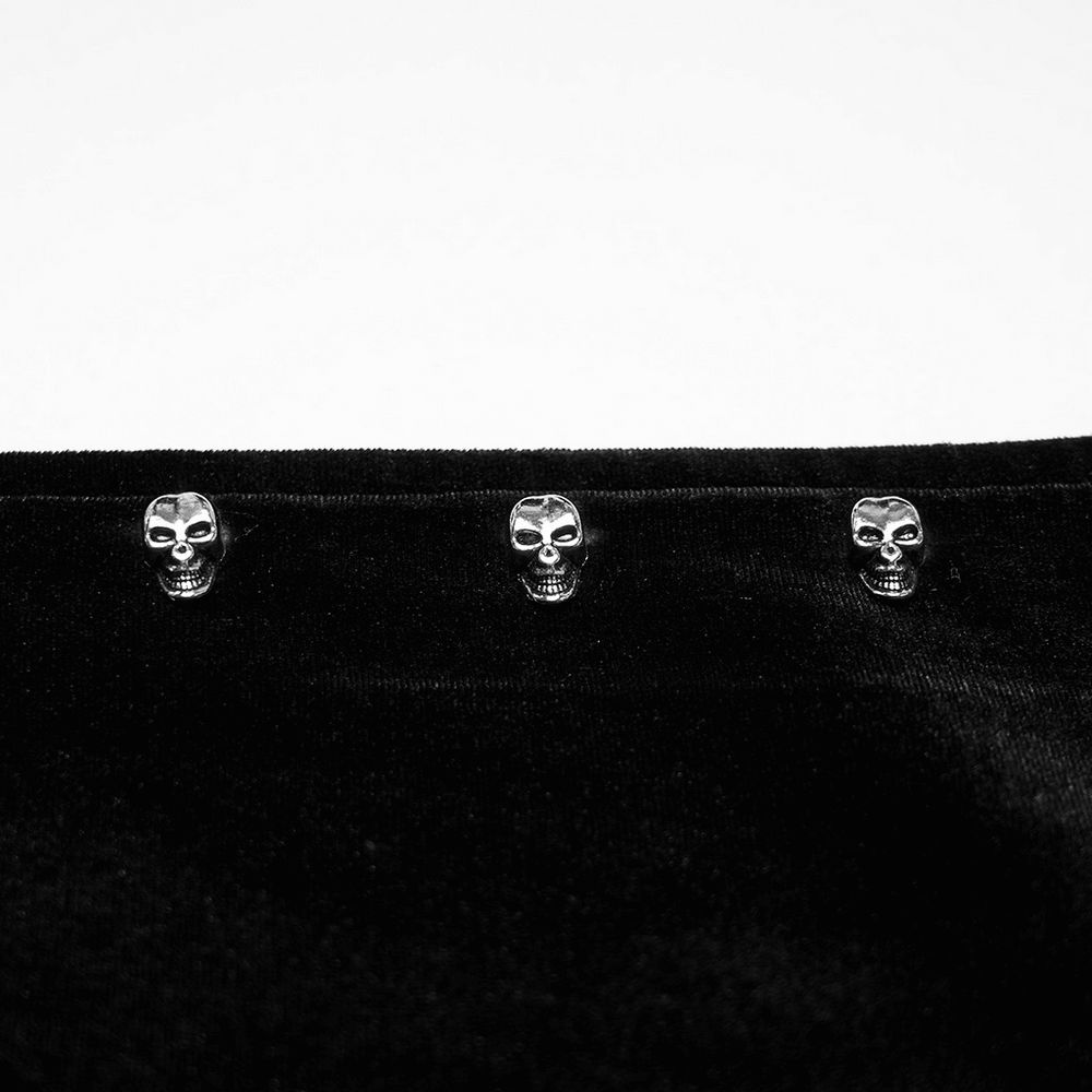 Close-up of skull studs on black faux leather jacket, showcasing punk style and gothic fashion details.