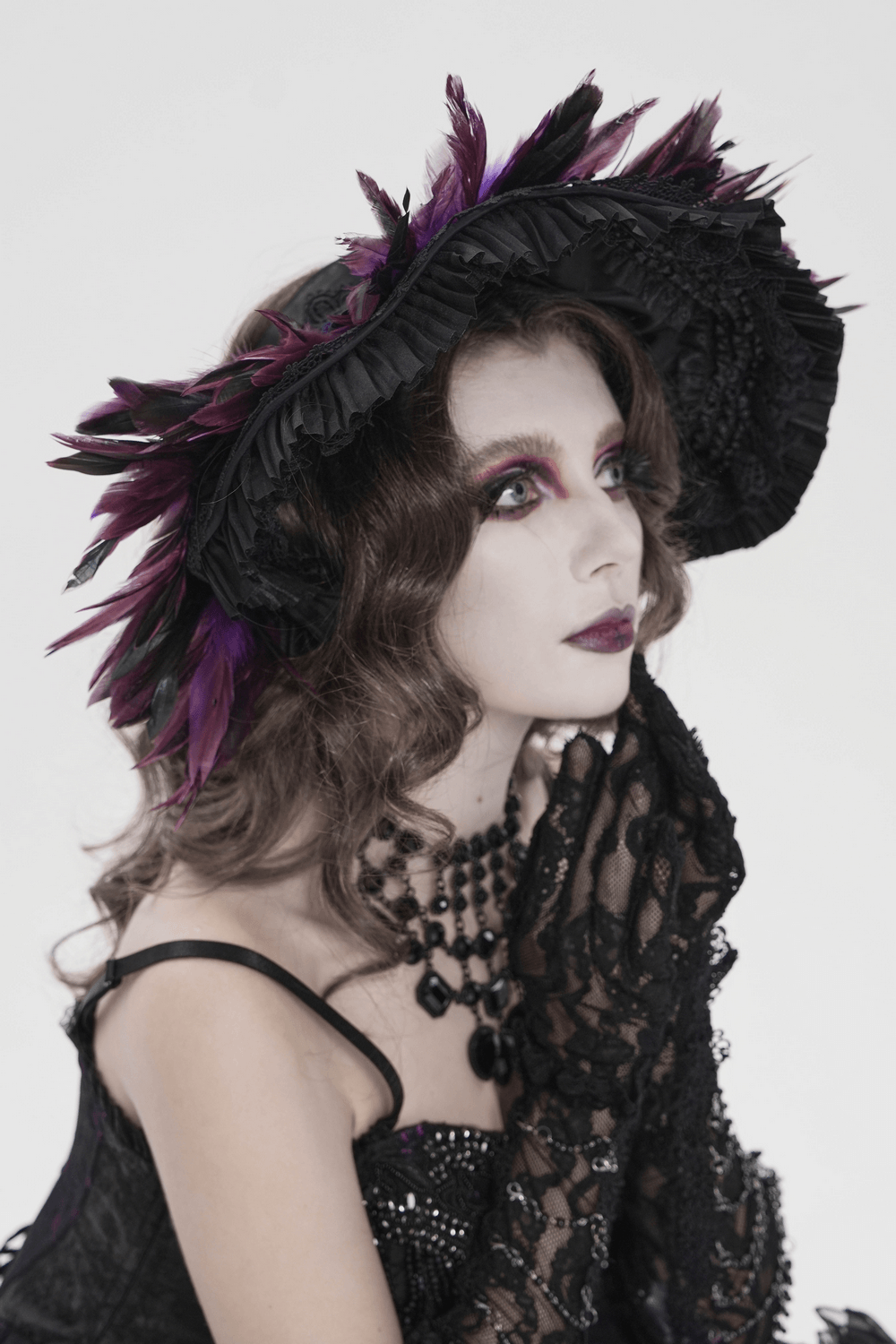 Gothic Feather Halo Bonnet Headdress for Women worn by a model with dramatic makeup and lace gloves, accentuating dark fantasy vibes.