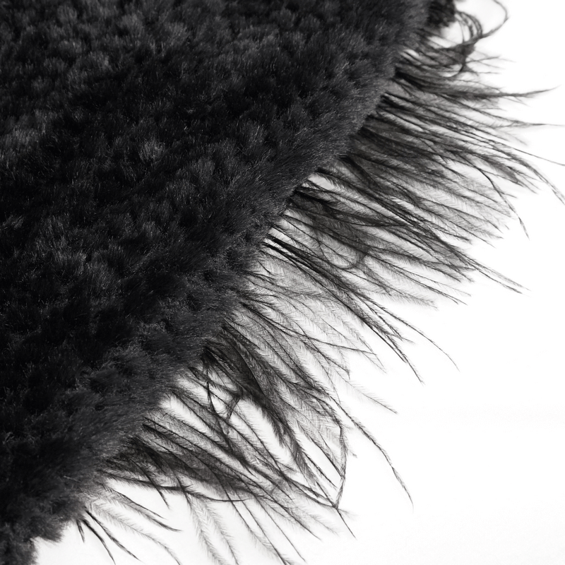 Close-up of black grained plush fabric with long black fringe, perfect for a gothic hooded cape.
