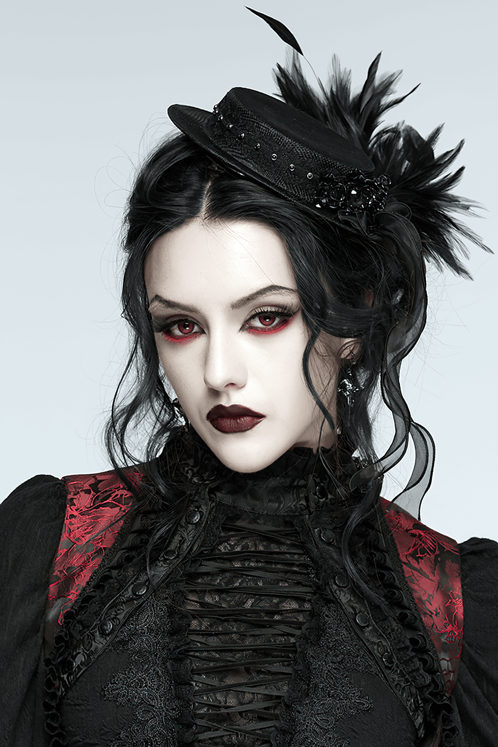 Gothic Feather Mini Hat with Ribbons and Vintage Flair worn by model showcasing its dramatic elegance.