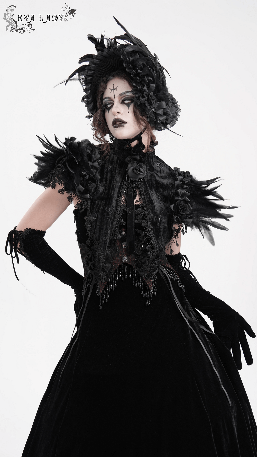 Elegant gothic model in feathered cape with lace trims and velvet roses, exuding Victorian charm and dramatic style.