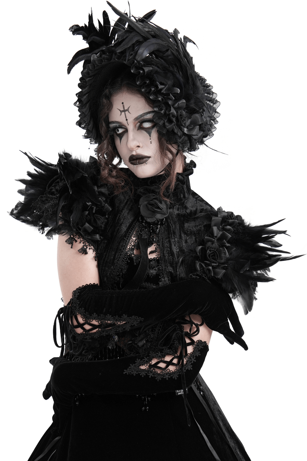 Gothic fashion model wearing a dramatic feathered cape with lace trims and velvet roses, showcasing Victorian elegance.