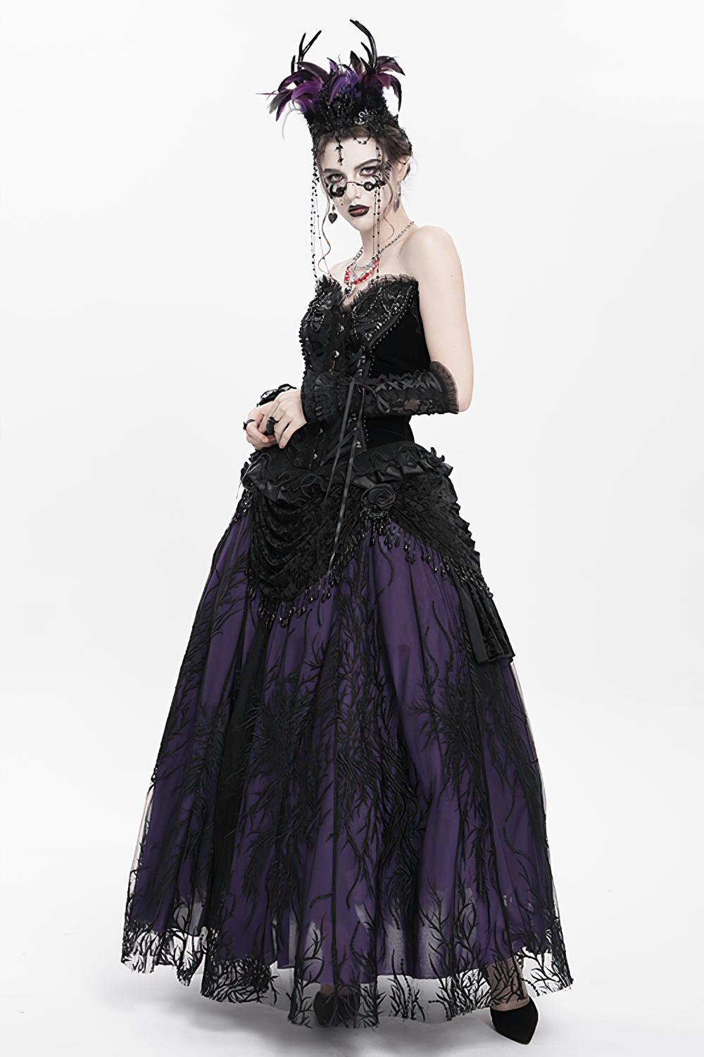 Elegant Gothic outfit featuring a purple skirt, black top, and striking feathered headpiece for a dark, dramatic look.