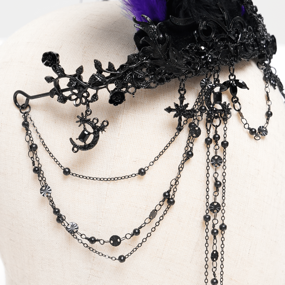 Detailed view of chains and cross ornaments on a Gothic feathered headpiece, featuring black and purple accents.