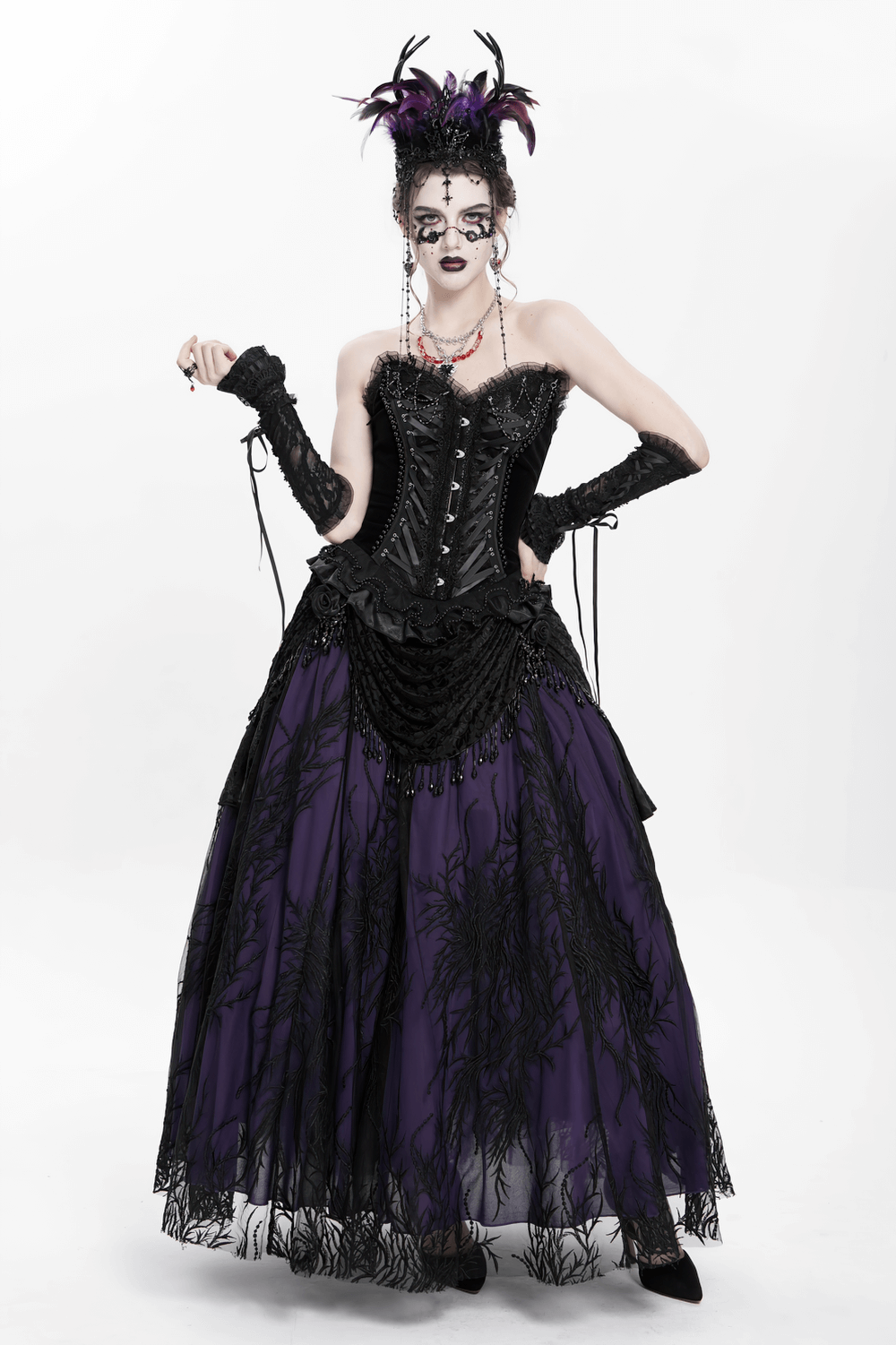 Elegant model in a dramatic black and purple Gothic dress with feathered headpiece and intricate details.