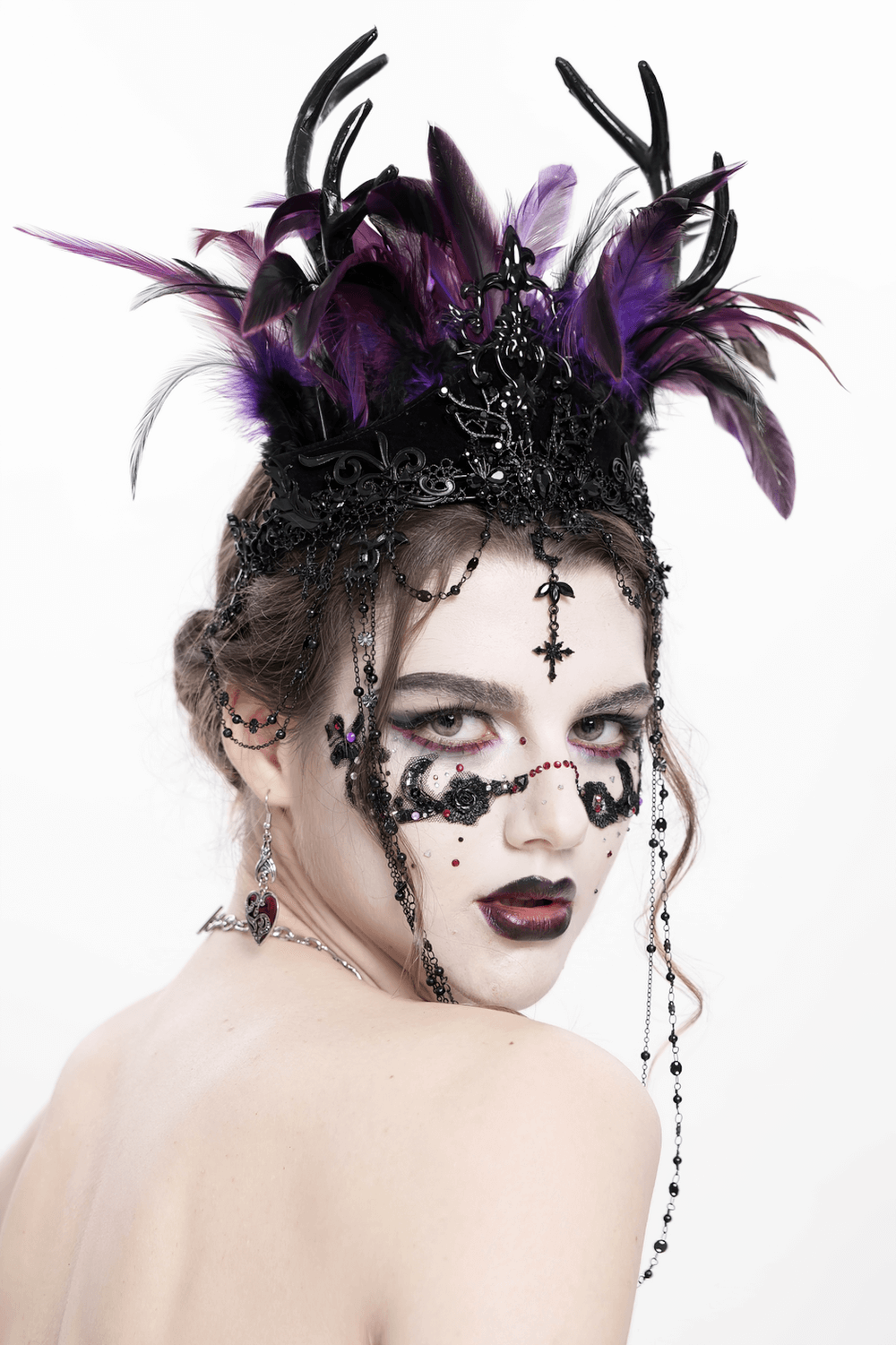 Gothic feathered headpiece with chains and cross ornaments, showcasing dark elegance and dramatic style.
