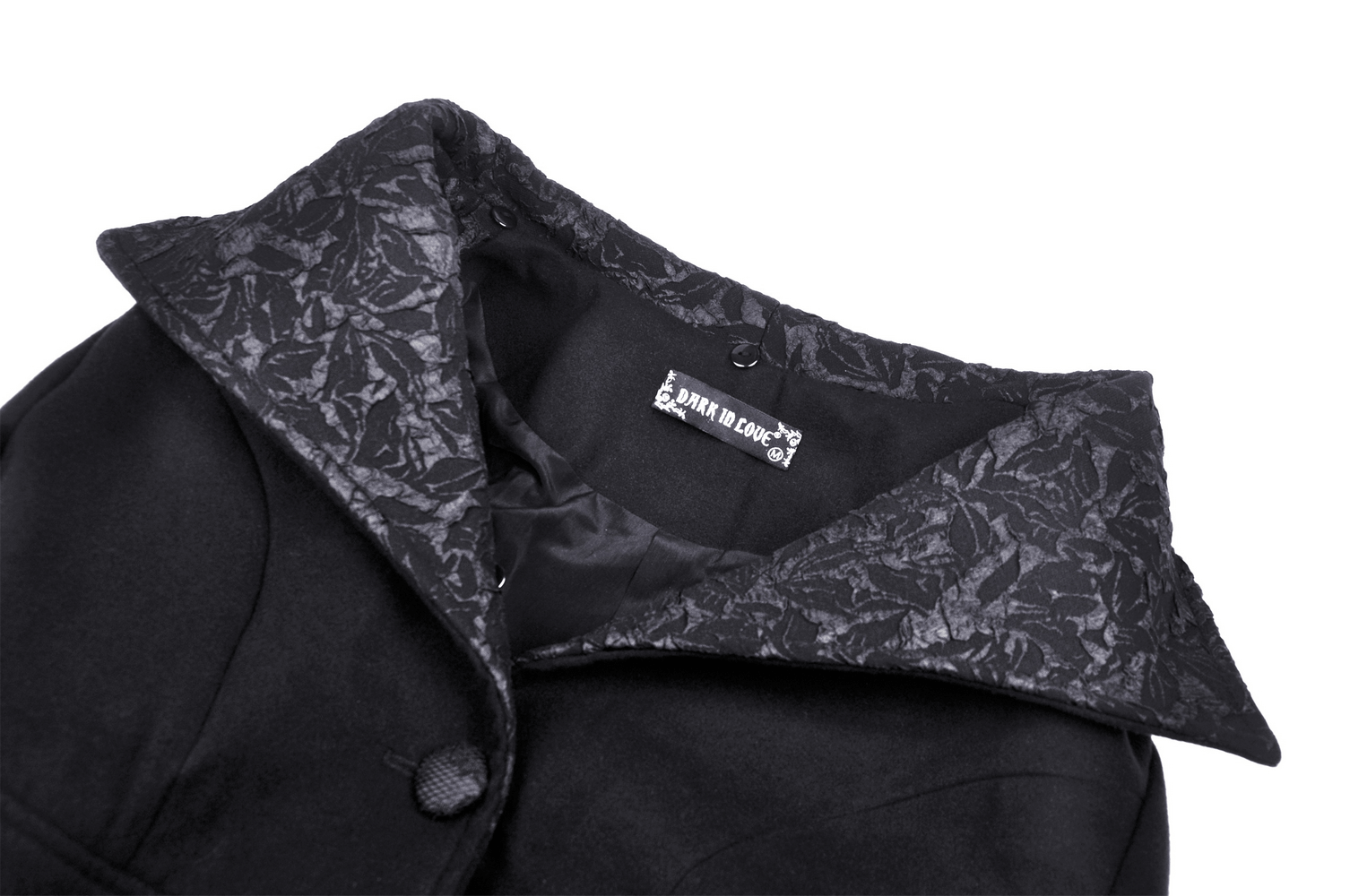 Close-up of a gothic black coat collar with plush lining and detailed texture for elegant style.