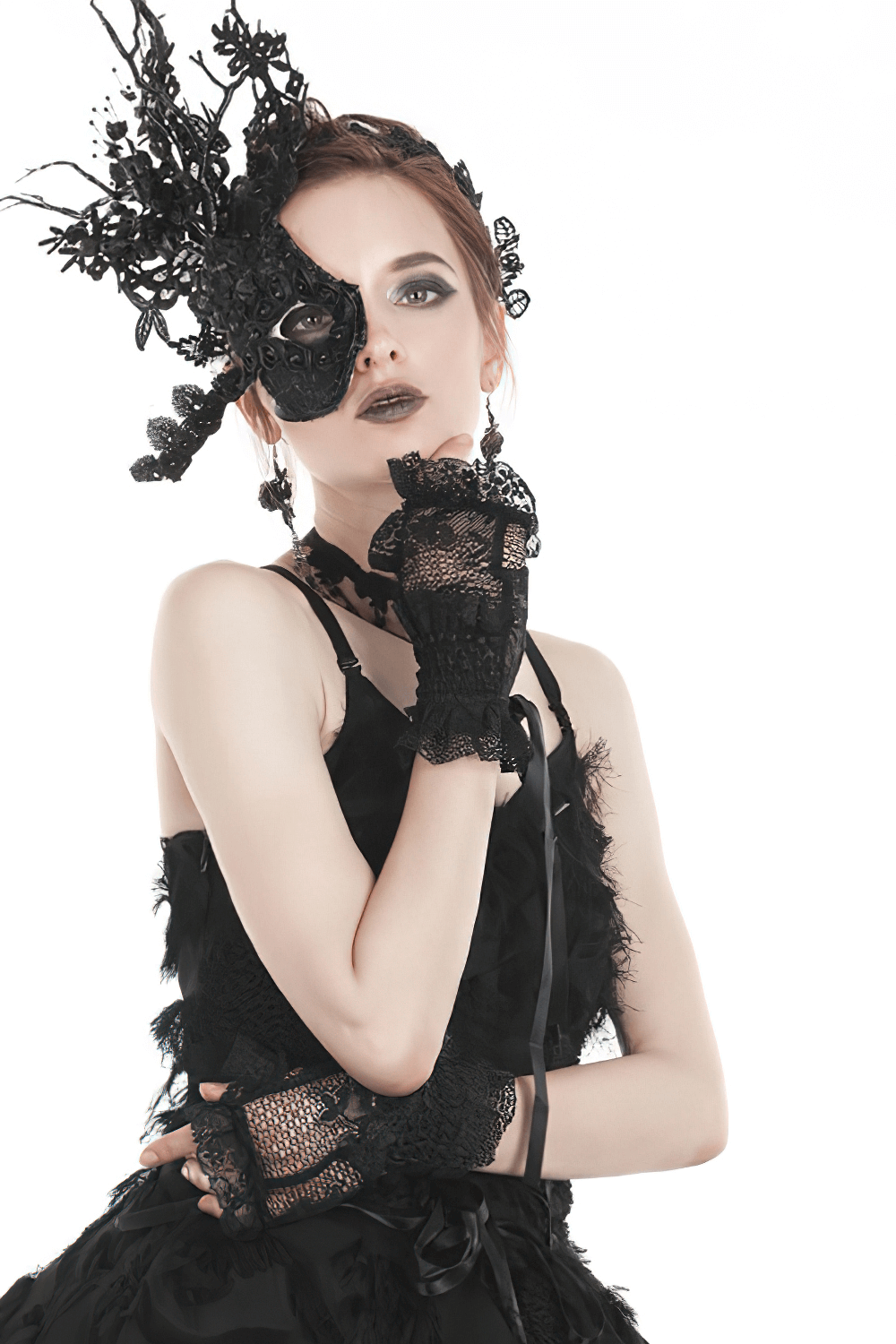 Gothic beauty wearing black lace fingerless gloves and an intricate mask, exuding dark elegance and style.