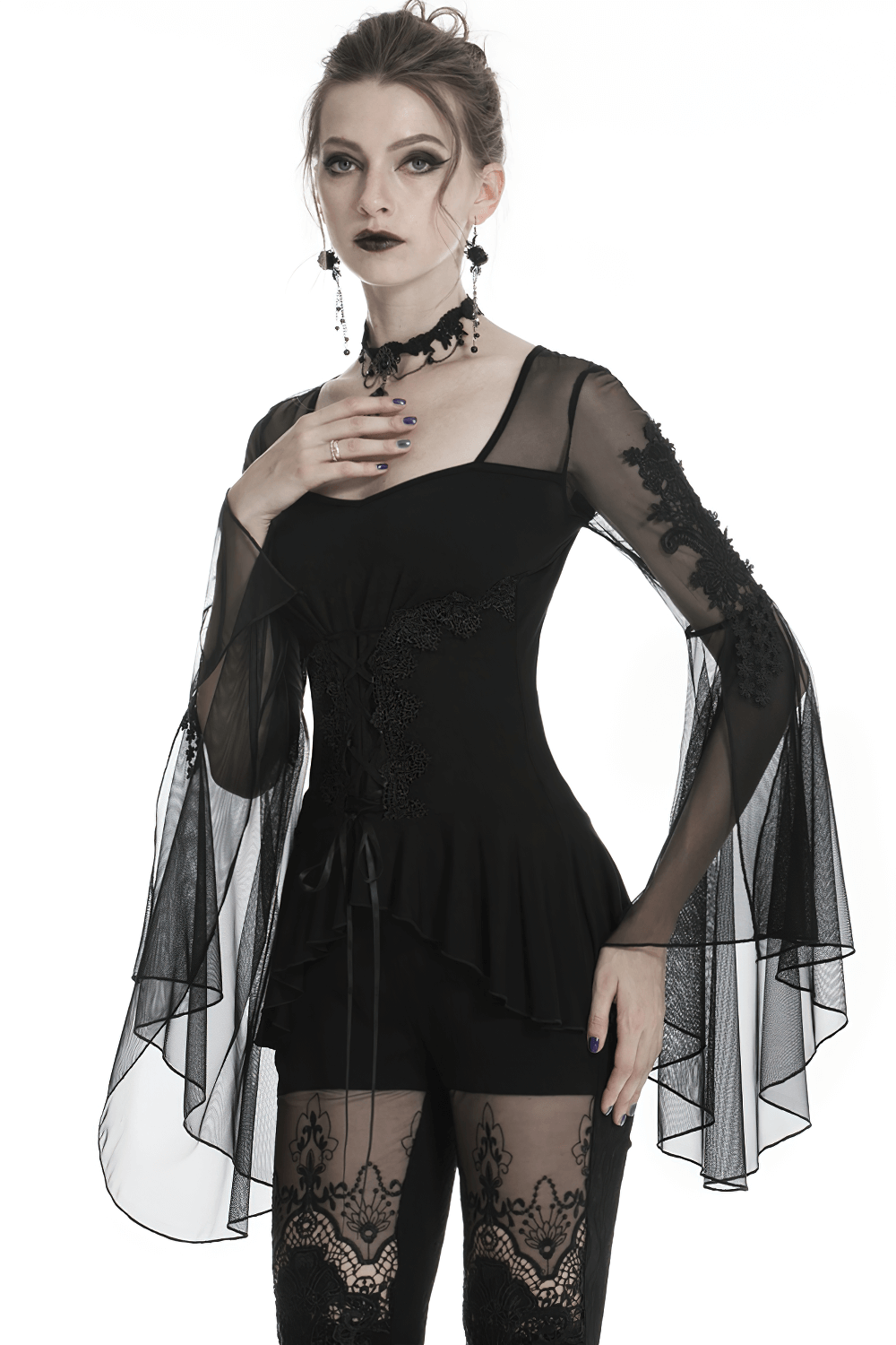 Gothic female model wearing a lace-up ruffled top with sheer sleeves, showcasing a dark, elegant style.