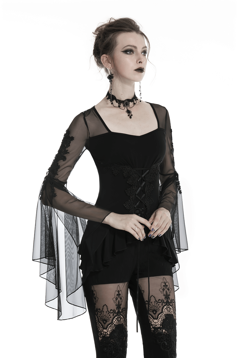 Gothic female model wearing a lace-up ruffled top with sheer sleeves and dark details, showcasing elegance and mystery.