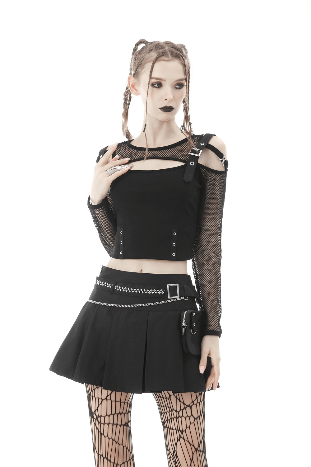 Gothic female model wearing black mini skirt with chain belt and mesh top, exuding dark punk style.