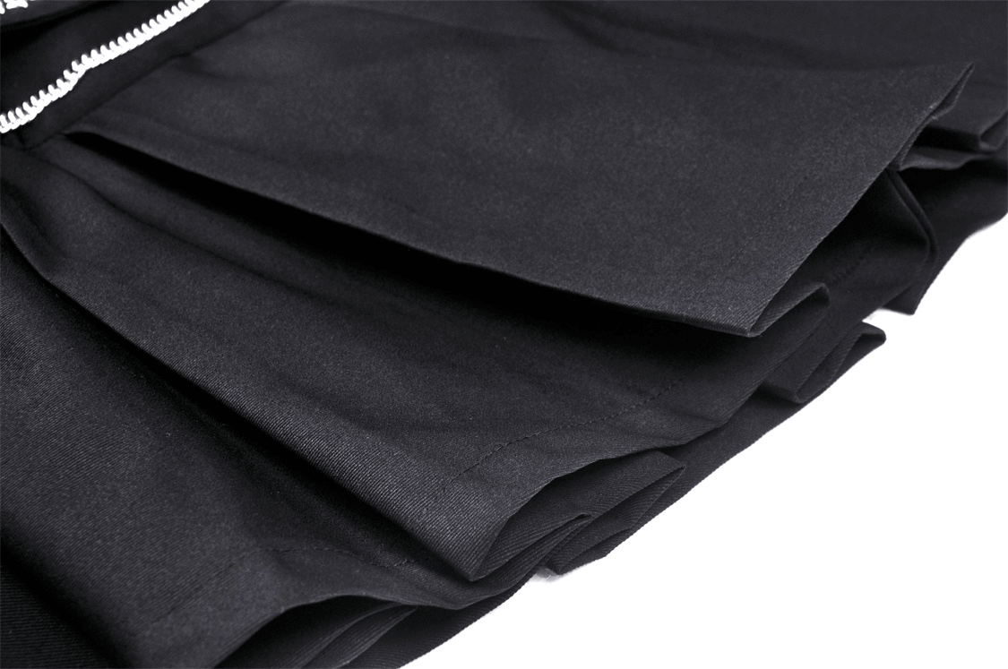 Close-up of black pleated gothic mini skirt showcasing its texture and chain belt for a punk-inspired look.