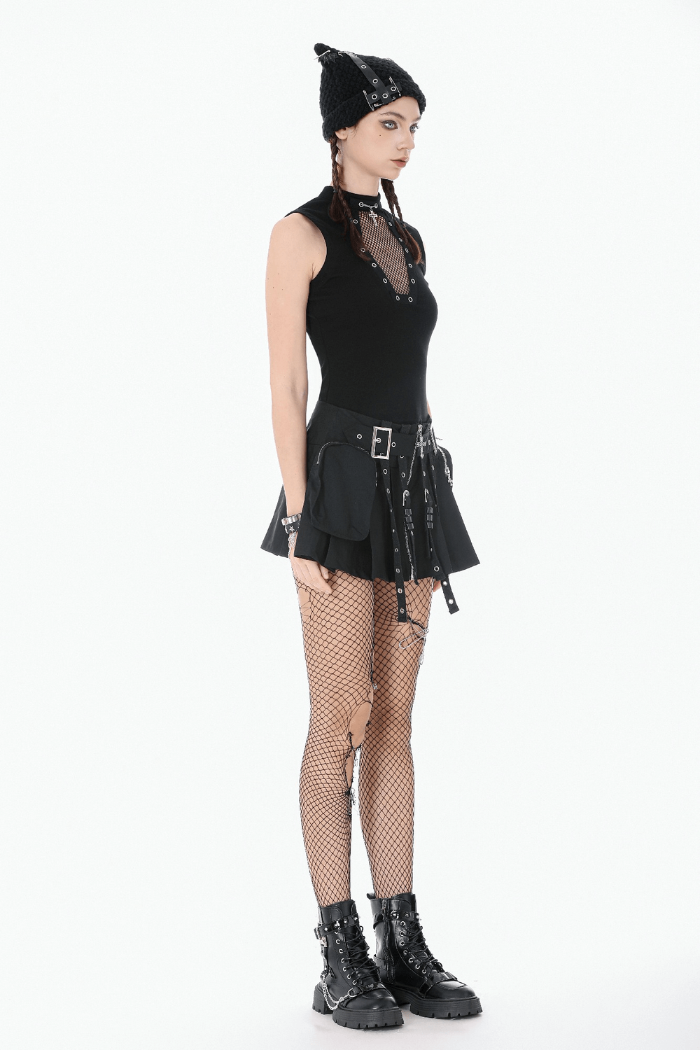 Gothic Fishnet Cutout Sleeveless Mock Neck Top worn with a stylish mini skirt, fishnet tights, and edgy accessories.