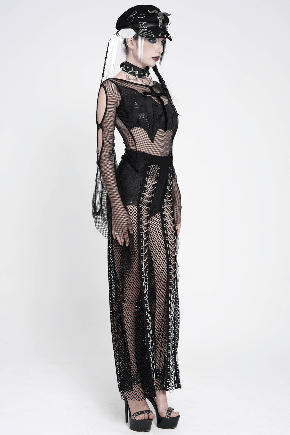 Gothic Fishnet Lace Up Flare Pants with Chains, styled with a sheer top, black hat, and layered accessories.