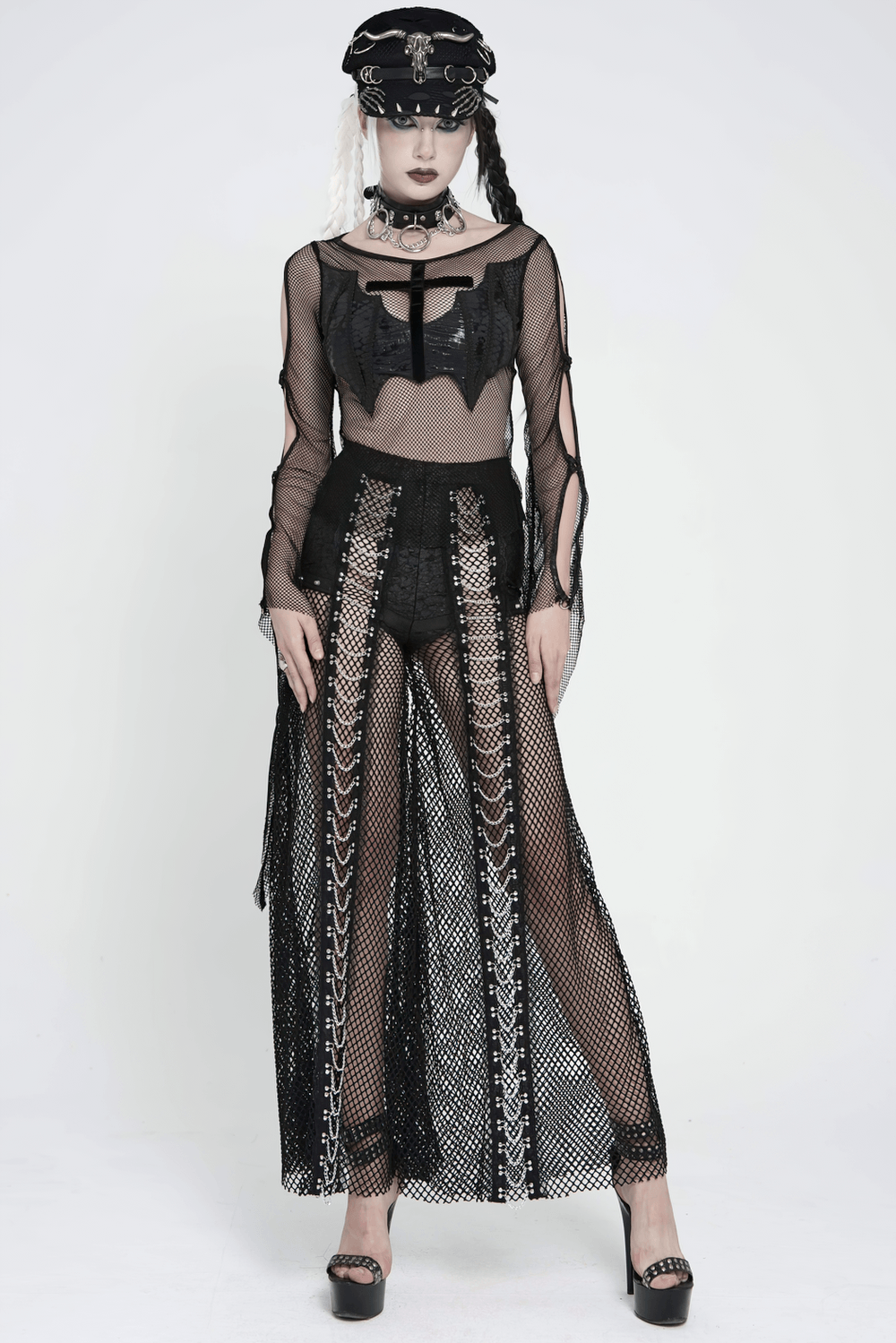 Gothic Fishnet Lace Up Flare Pants with Chains styled with a bat top, showcasing punk fashion in black mesh and a dramatic silhouette.