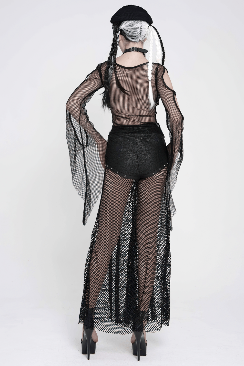 Gothic Fishnet Lace Up Flare Pants with Chains worn by a model showcasing the dramatic wide leg silhouette and silver accents.