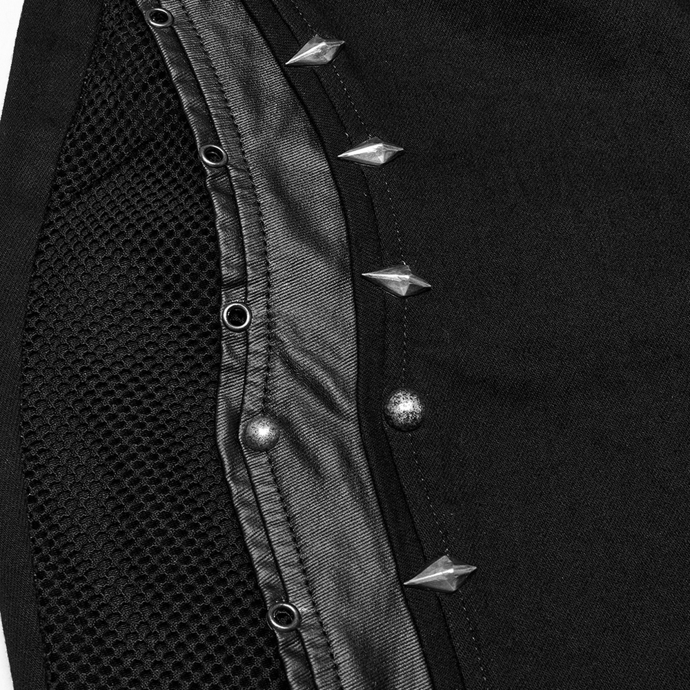 Close-up of gothic flared pants featuring silver-tone studs and mesh panels for a punk rock vibe.