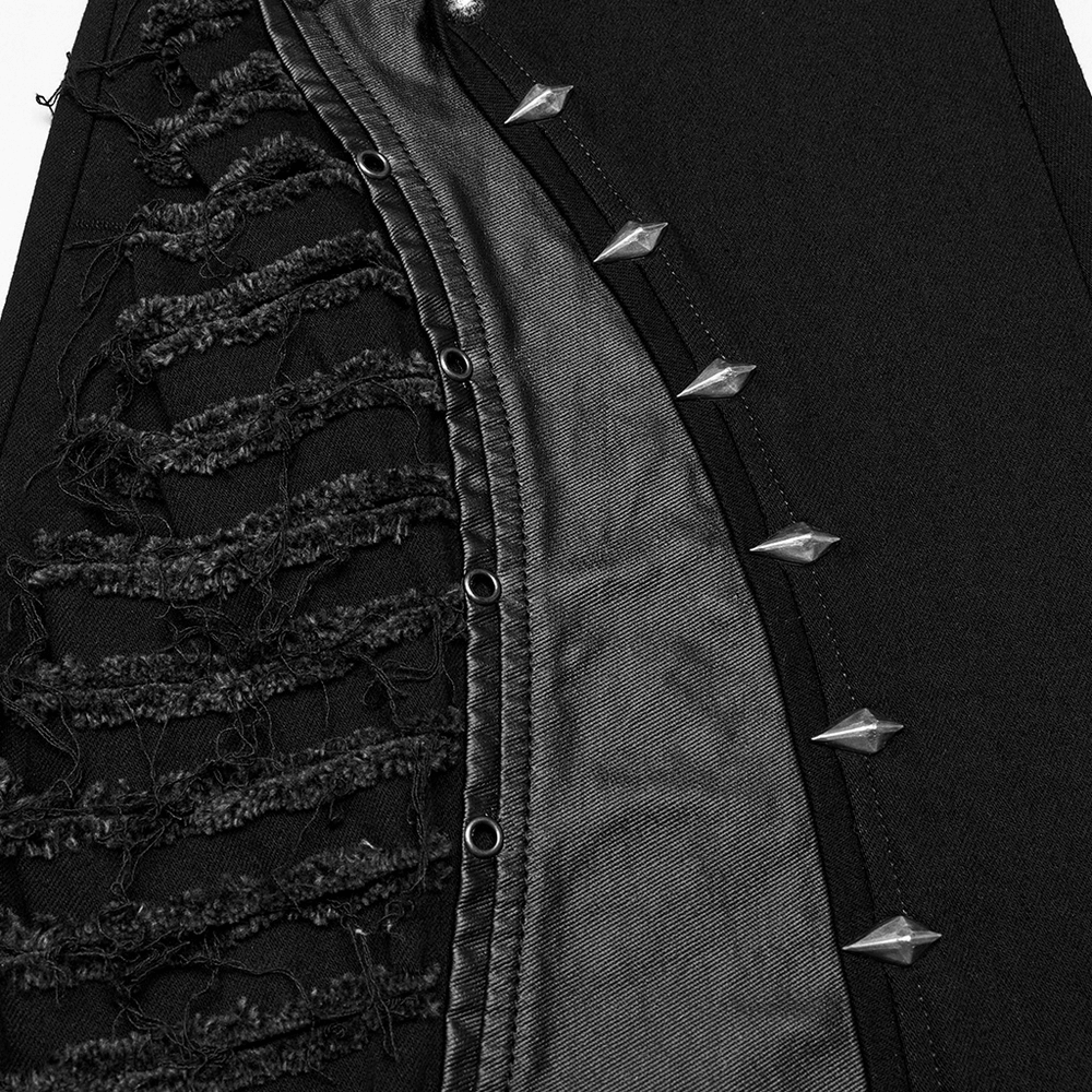 Close-up of Gothic flared pants showcasing faux leather, distressed edges, and studded detailing.