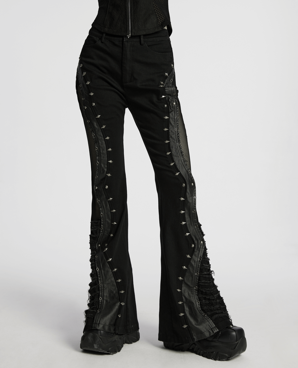 Gothic flared pants with studded details and mesh panels, showcasing a punk style and edgy silhouette.
