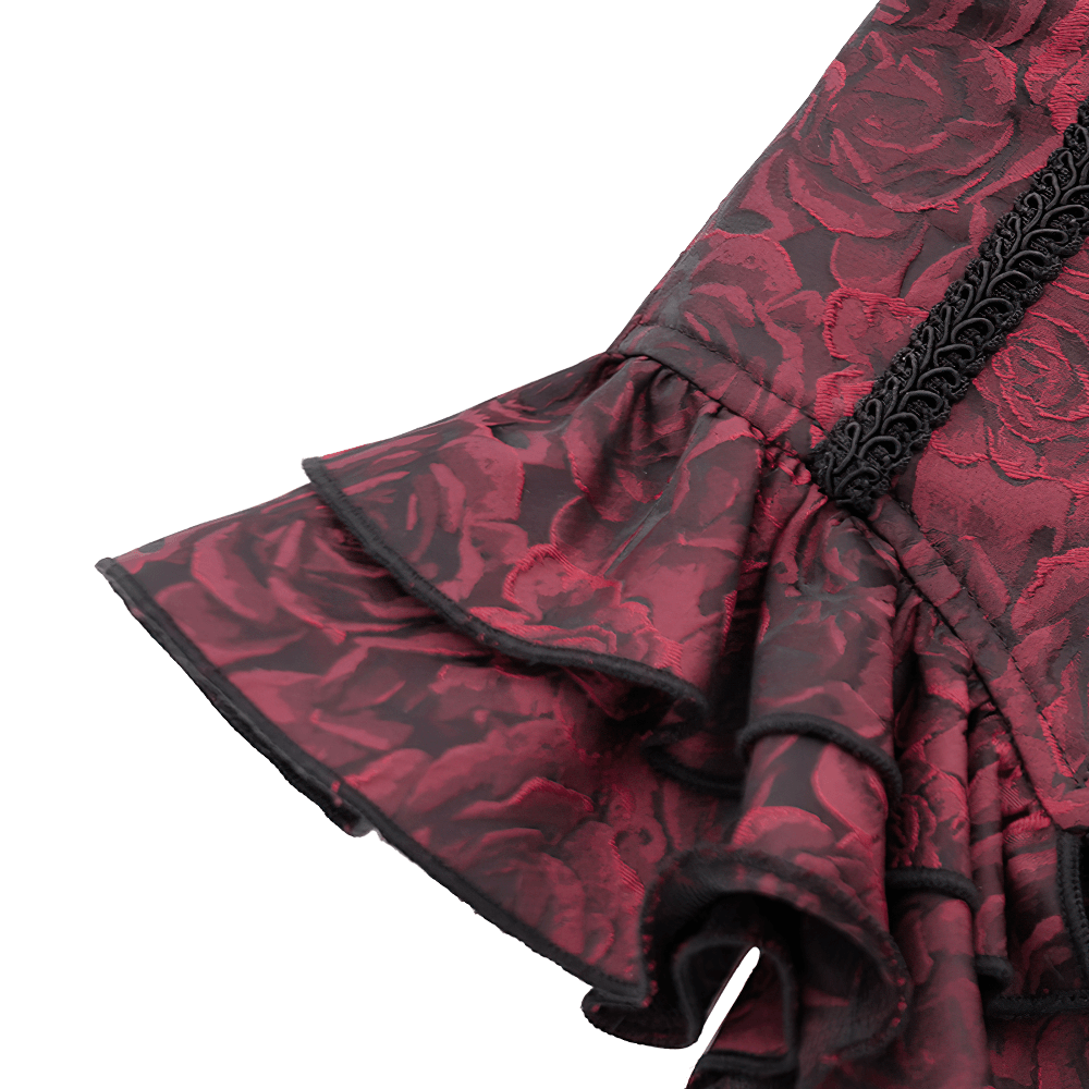 Close-up of gothic floral brocade waist corset's ruffled trim and intricate lace detailing.