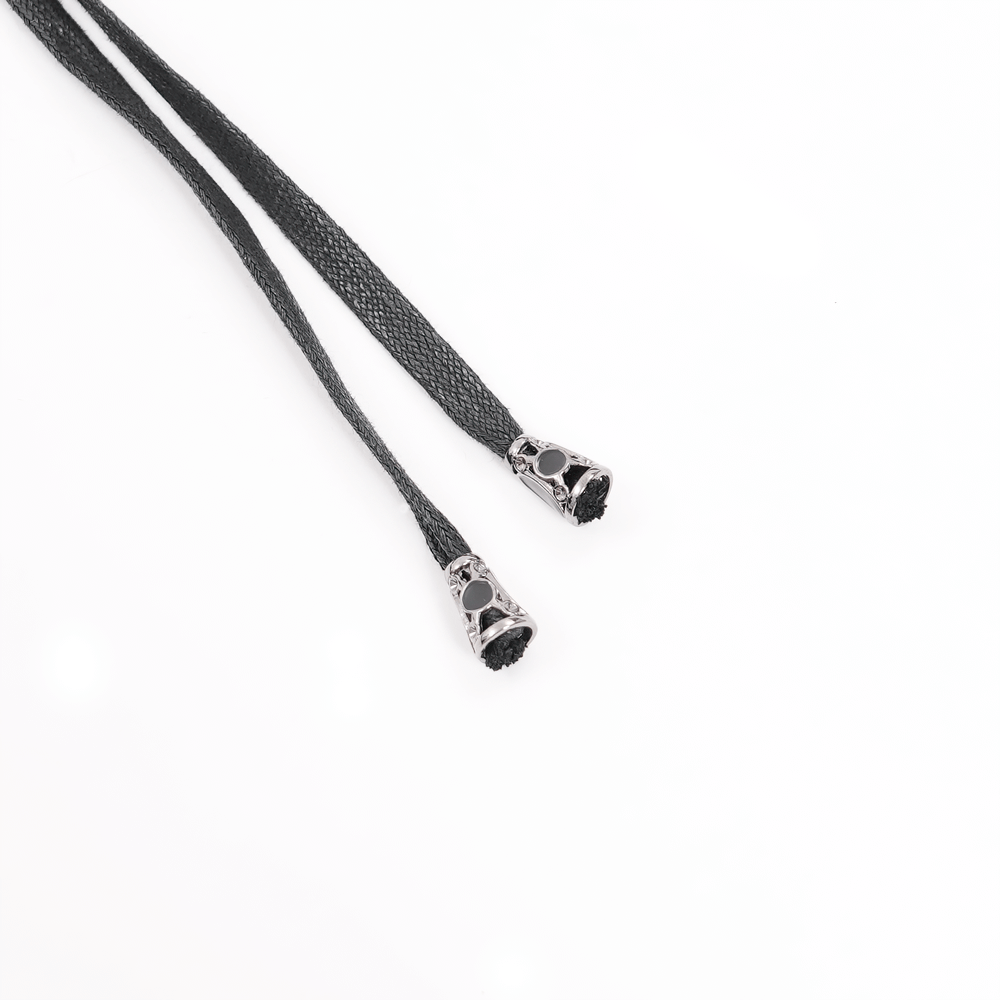 Black braided cords with decorative metal tips, perfect for gothic or vintage accessories and details.