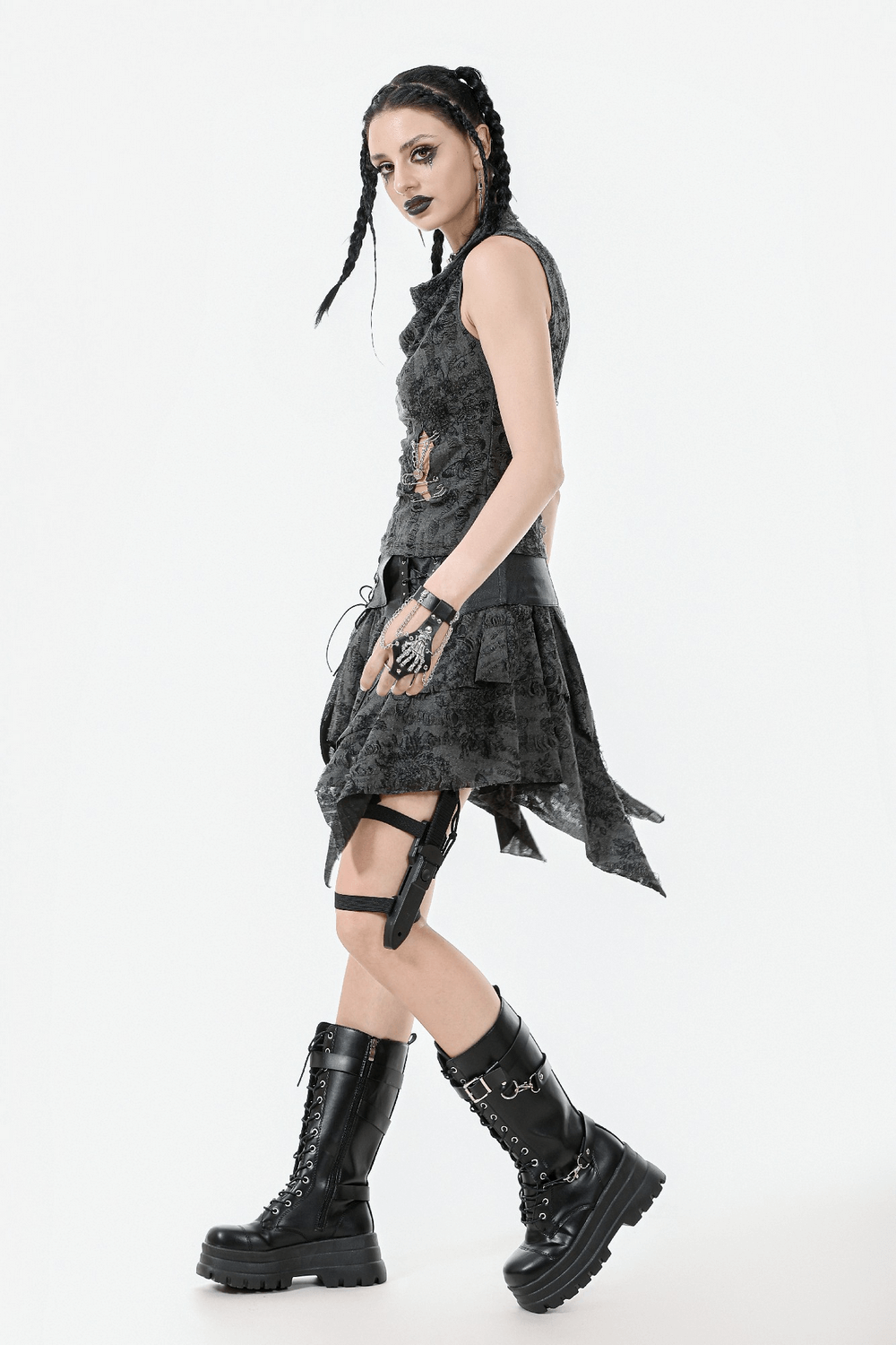 Gothic floral butterfly sleeveless top with chains and pins, styled with a black skirt and chunky boots.