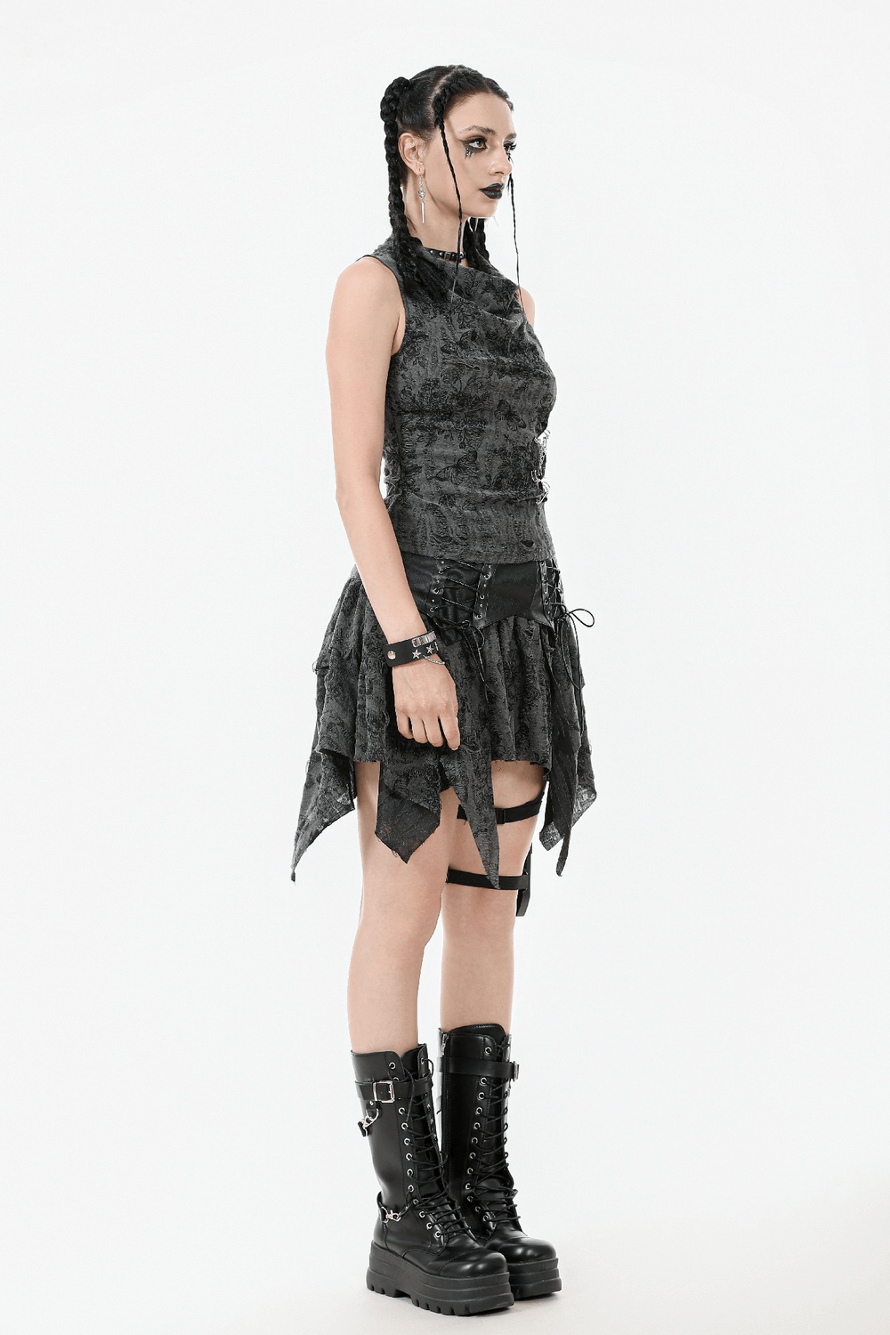 Gothic floral butterfly sleeveless top featuring chains and pins, styled with edgy accessories and bold black boots.