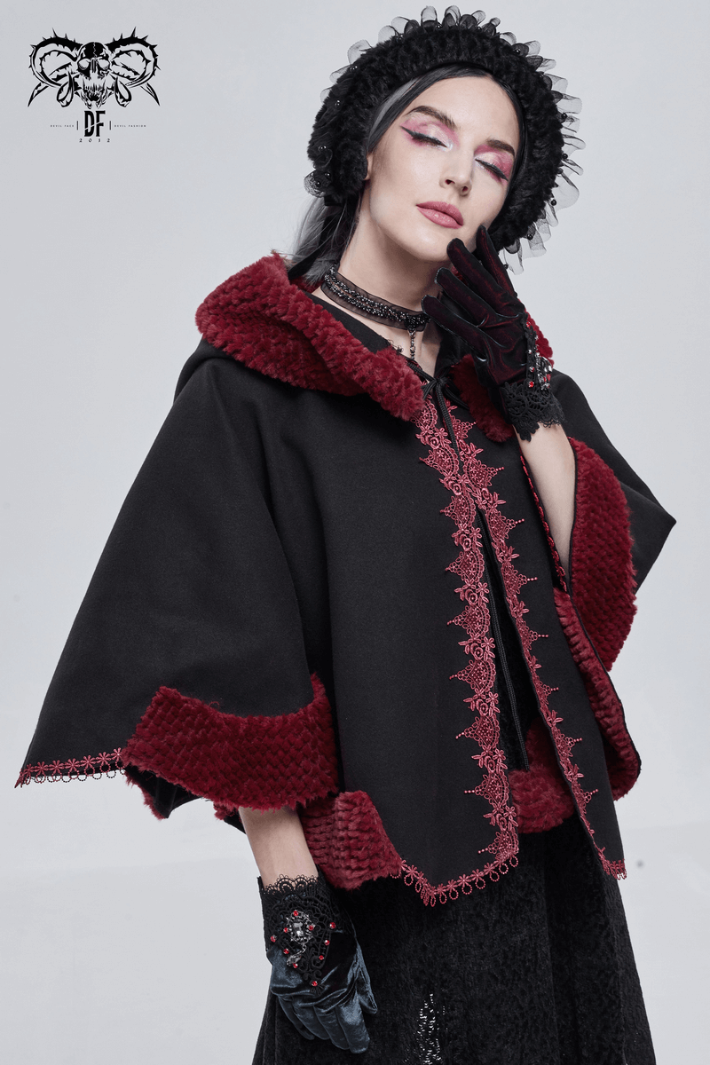Stylish woman wearing a black gothic cape with red pompons and vintage design, perfect for gothic fashion.