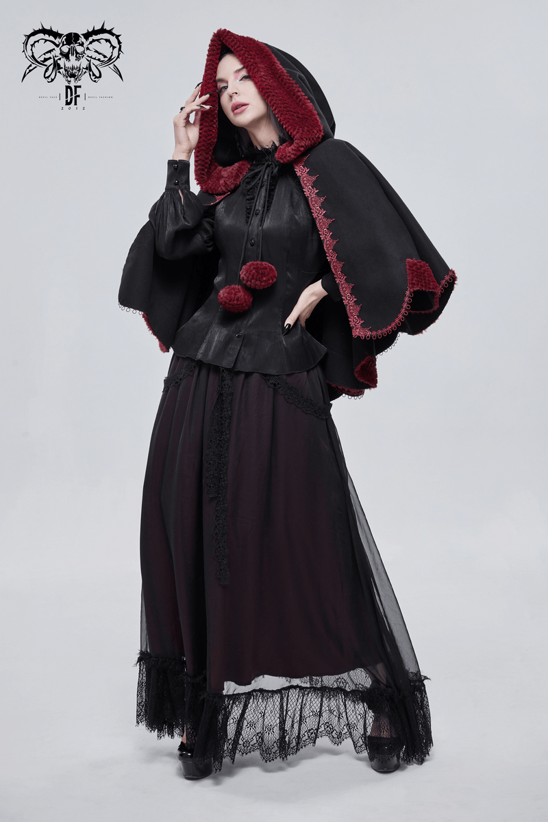 Gothic floral embroidered black cape with red pompoms worn by a model, showcasing a stylish vintage design.