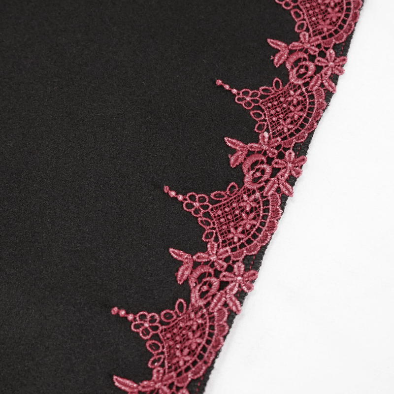Close-up of red guipure lace detailing on a black gothic cape, adding vintage charm and elegance.