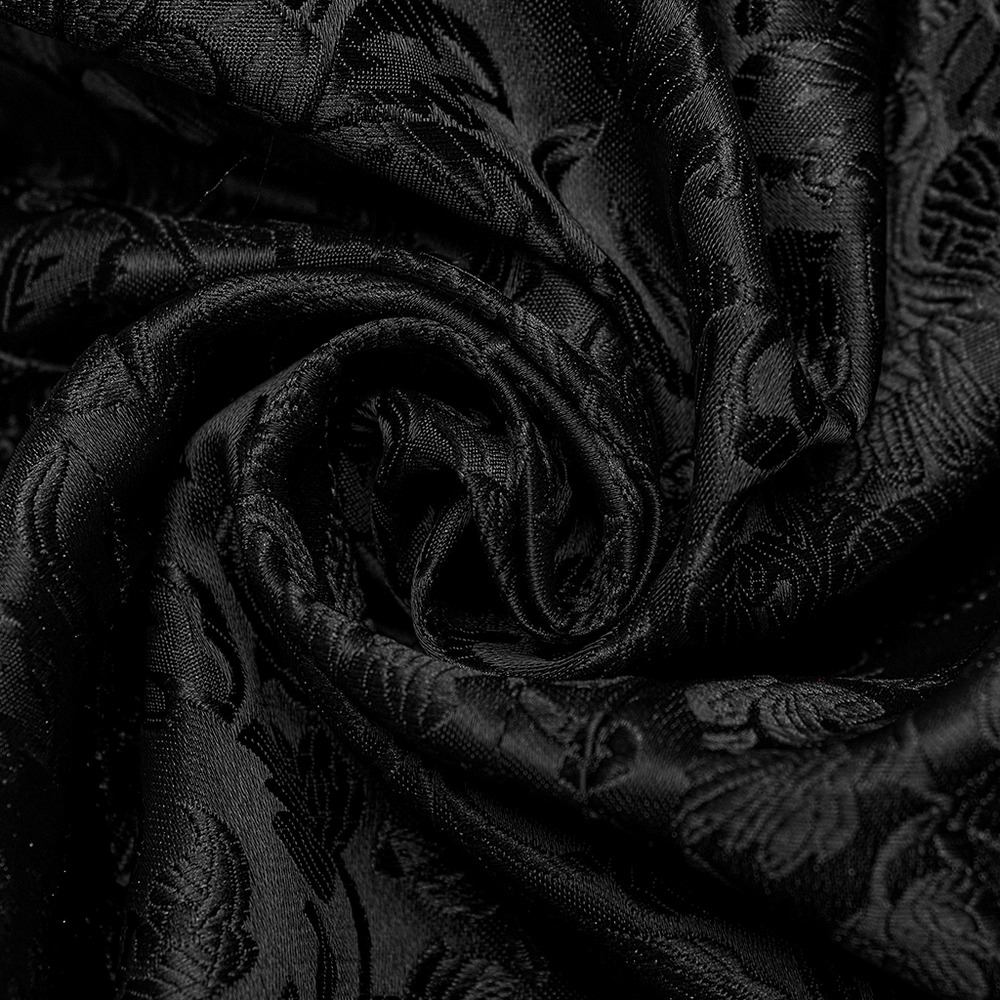 Close-up of black jacquard fabric with intricate floral patterns, perfect for gothic-inspired fashion.