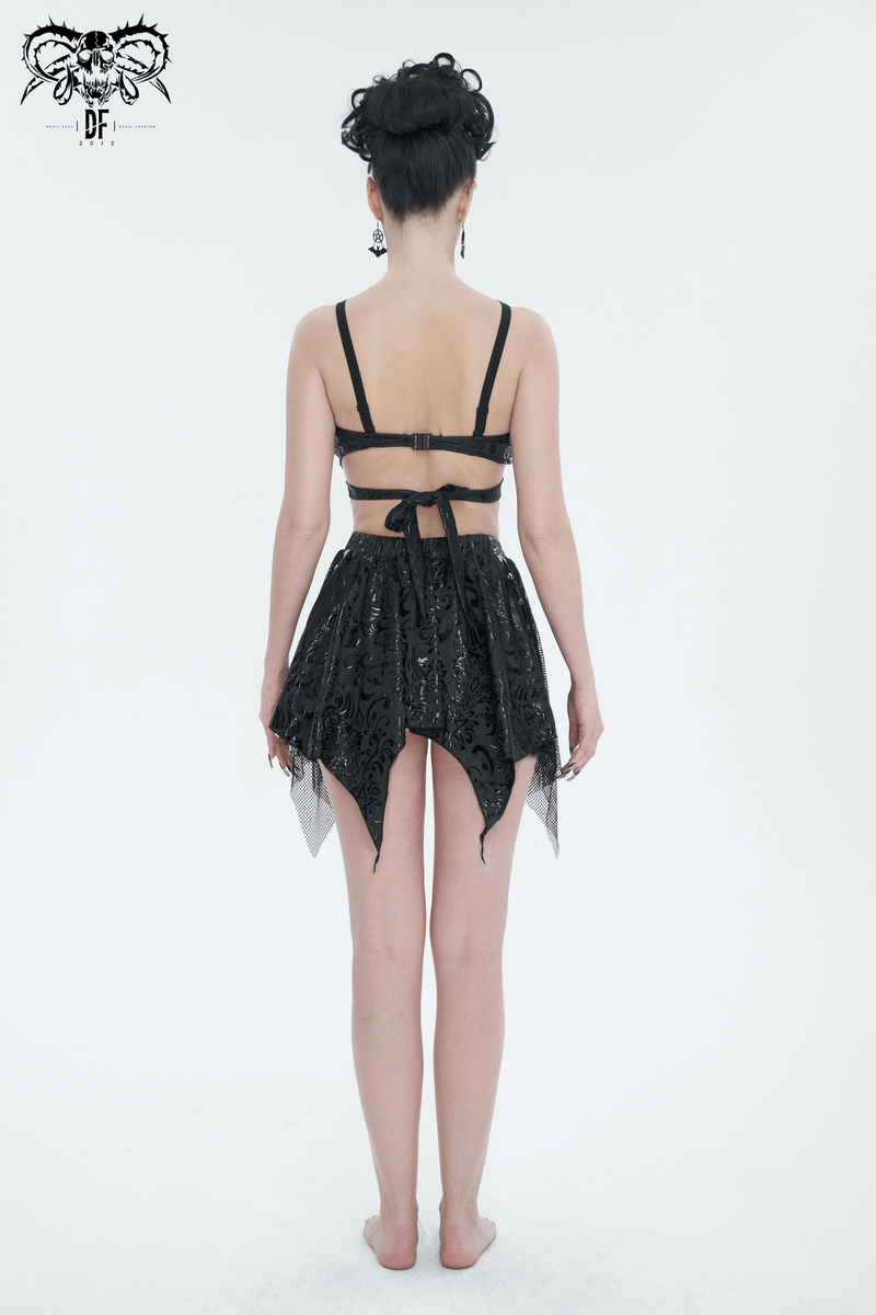 Back view of a woman in a gothic floral print swimsuit with star-shaped straps and irregular splice design.