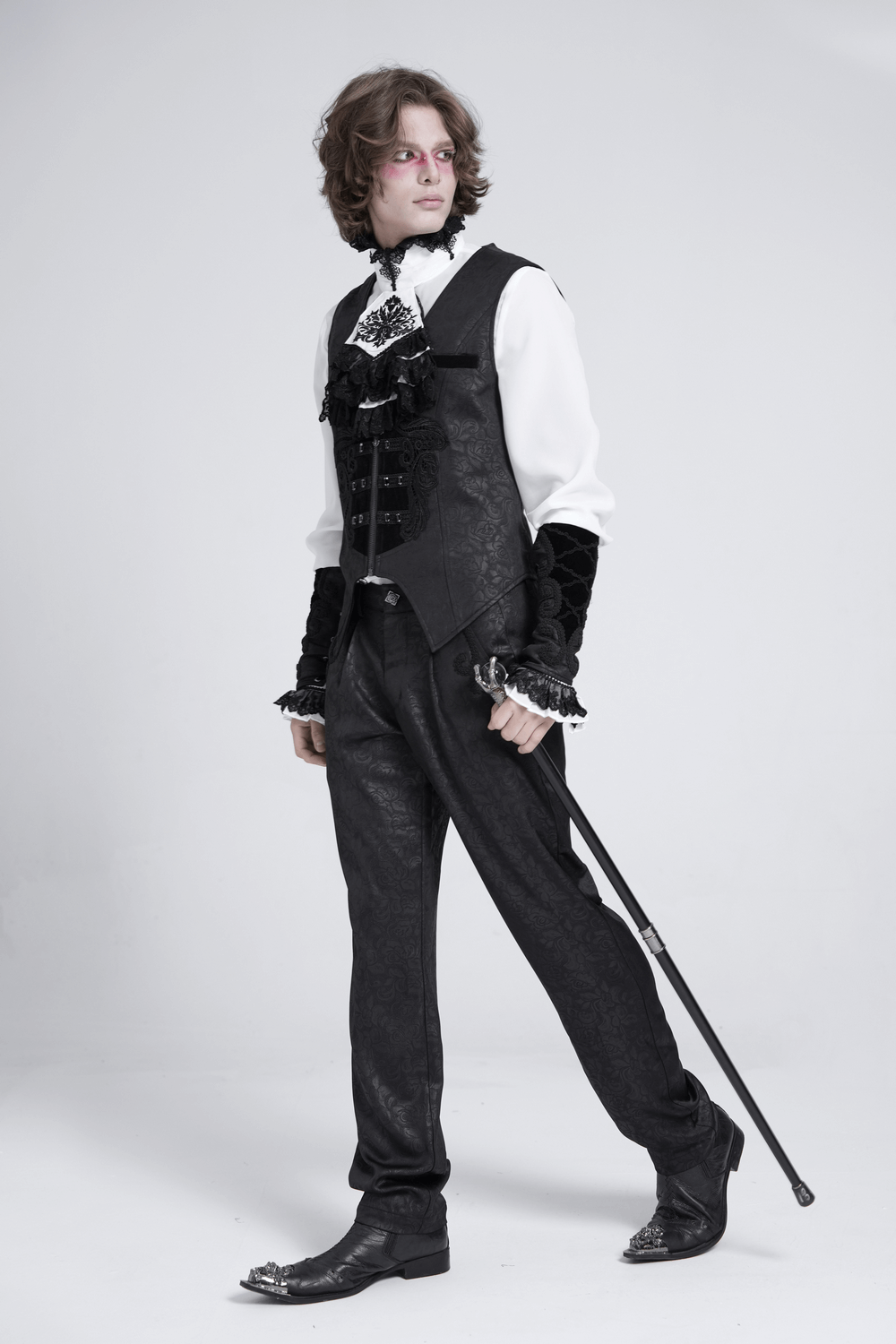 Model wearing a gothic floral waistcoat with velvet straps and cross detail, styled with Victorian elegance.