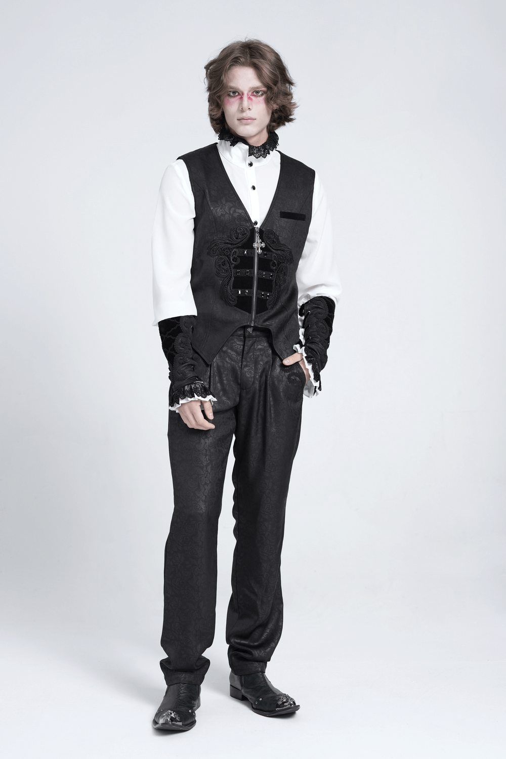 Gothic floral waistcoat with velvet straps and cross detail worn by a model, showcasing dark elegance in fashion.