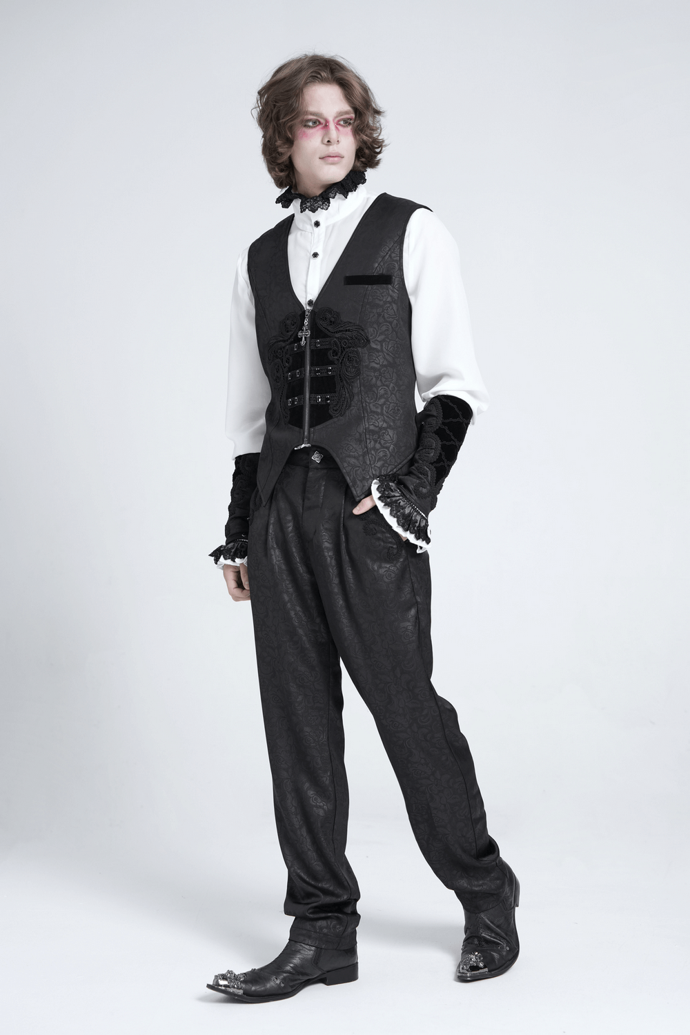 Gothic floral waistcoat with velvet straps and cross detail, paired with elegant black trousers and stylish boots.